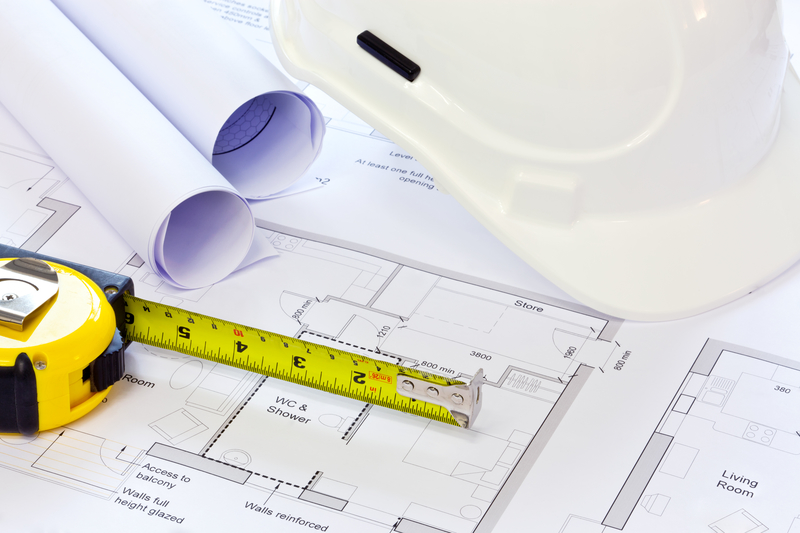 Hard hat and building plans new build plans